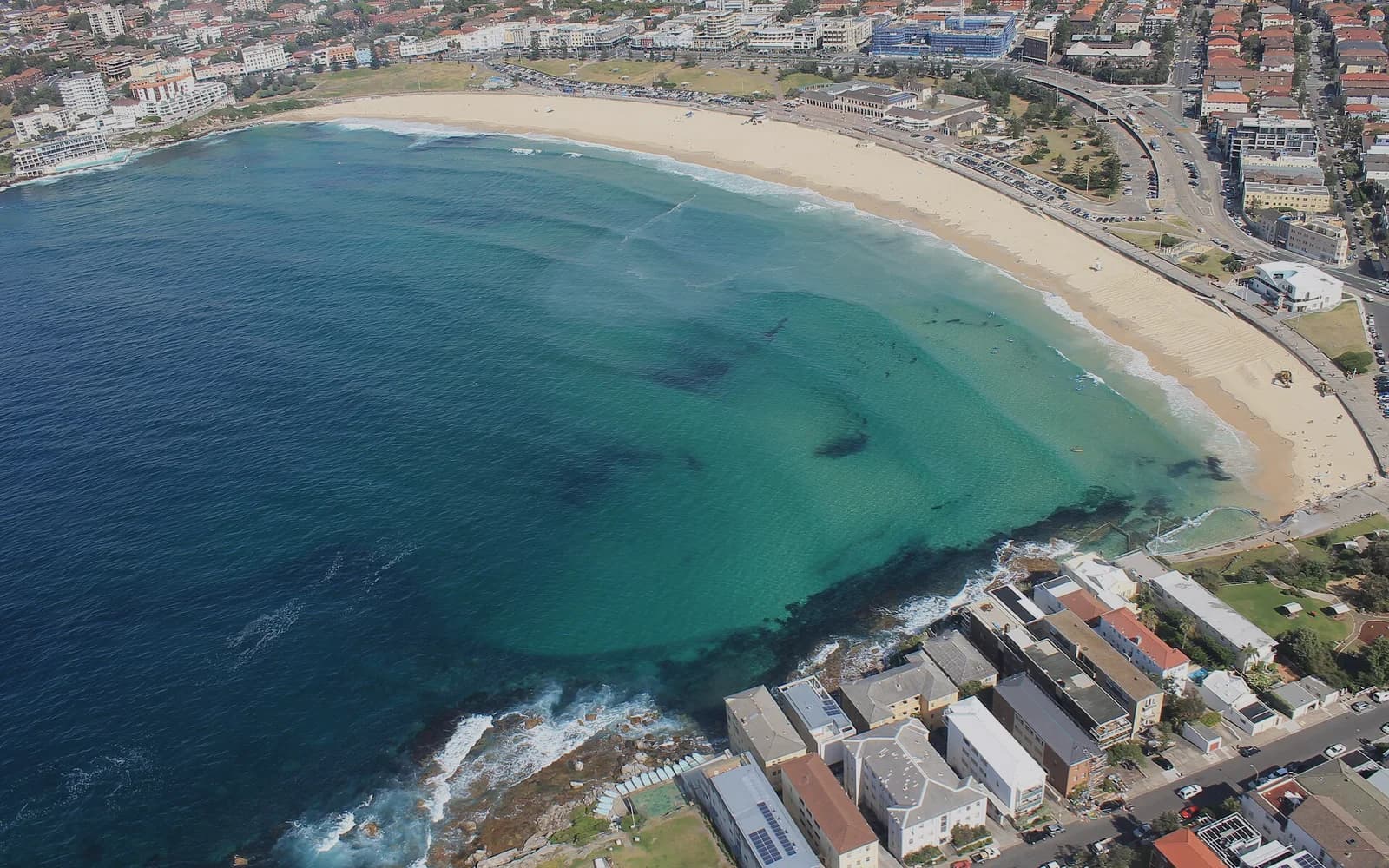 Aerial view of Bondi Beach, its crescent of sand and the surrounding streets