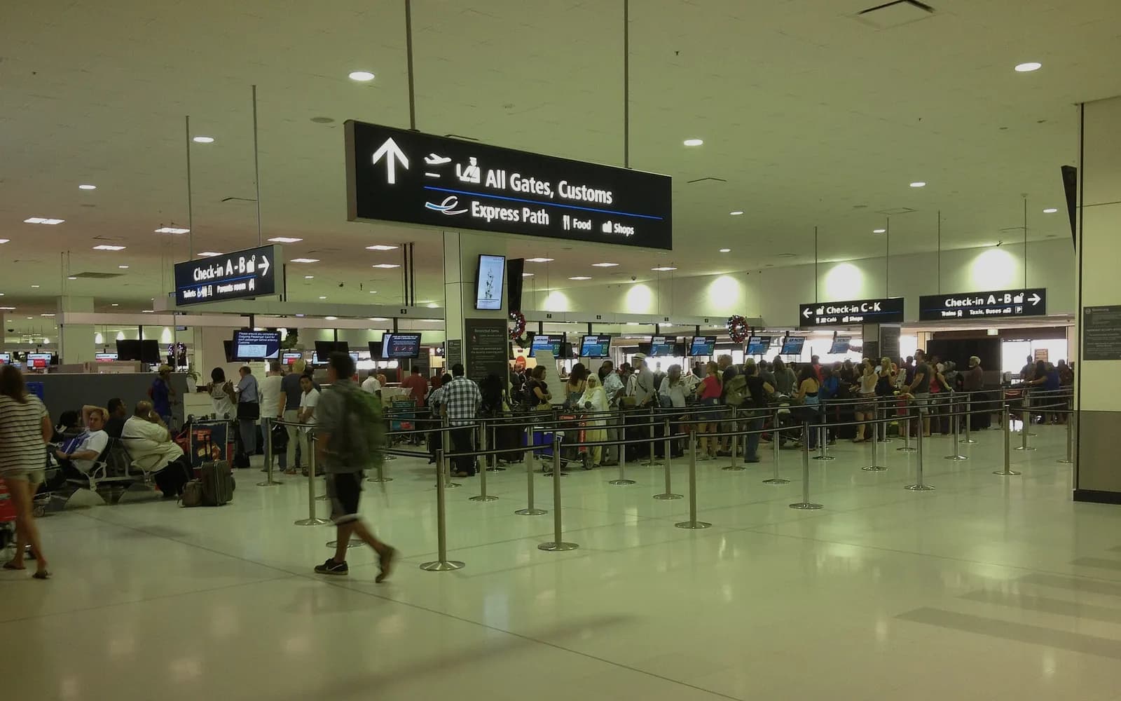 Travellers queueing at check-in inside Sydney Airport's international terminal