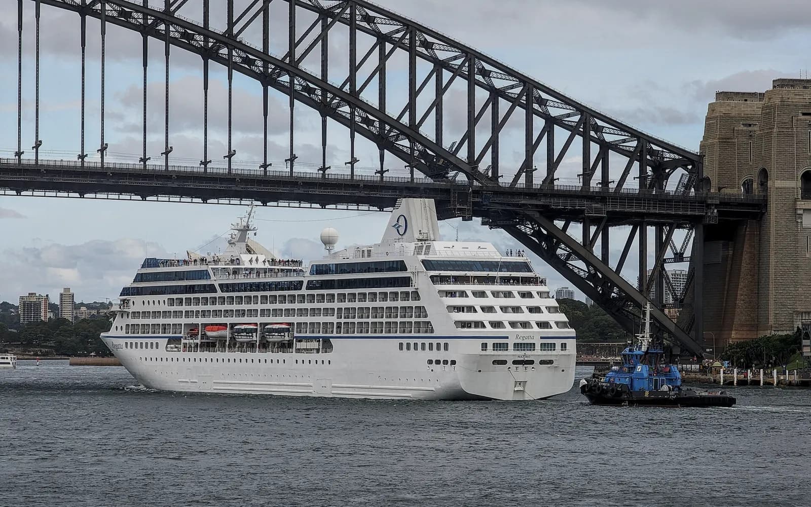A cruise ship passing beneath the Sydney Harbour Bridge after leaving White Bay